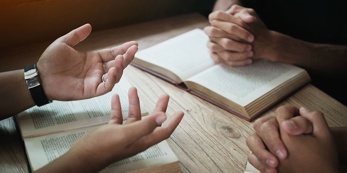 Christians are congregants join hands to pray and seek the blessings of God. Devotional or prayer meeting concept.
