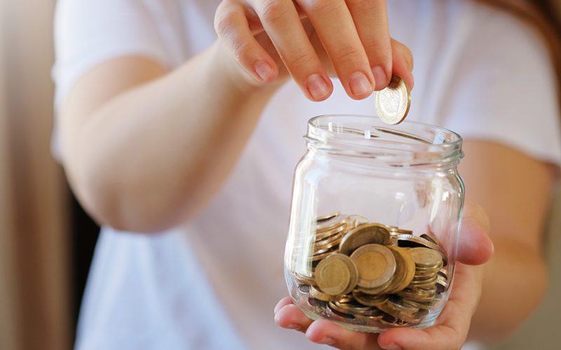 Turkish lira banknotes and coins in glass jar,woman hand. The paper currency of Turkey. Current Turkish liras are issued by The Central Bank of the Republic of Turkey. Financial crisis,saving concept