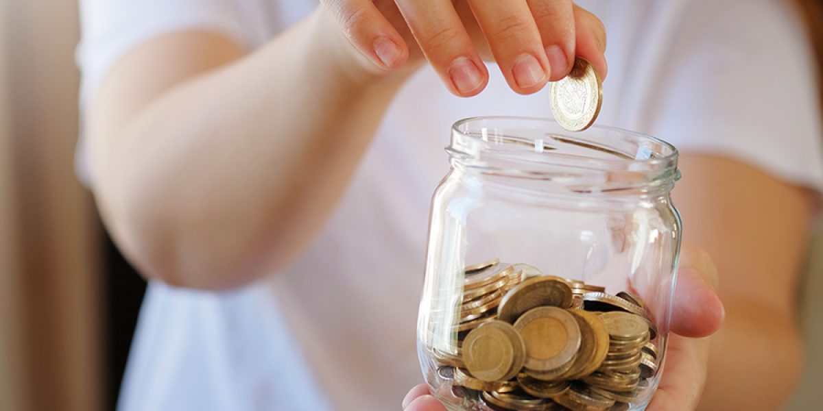 Turkish lira banknotes and coins in glass jar,woman hand. The paper currency of Turkey. Current Turkish liras are issued by The Central Bank of the Republic of Turkey. Financial crisis,saving concept