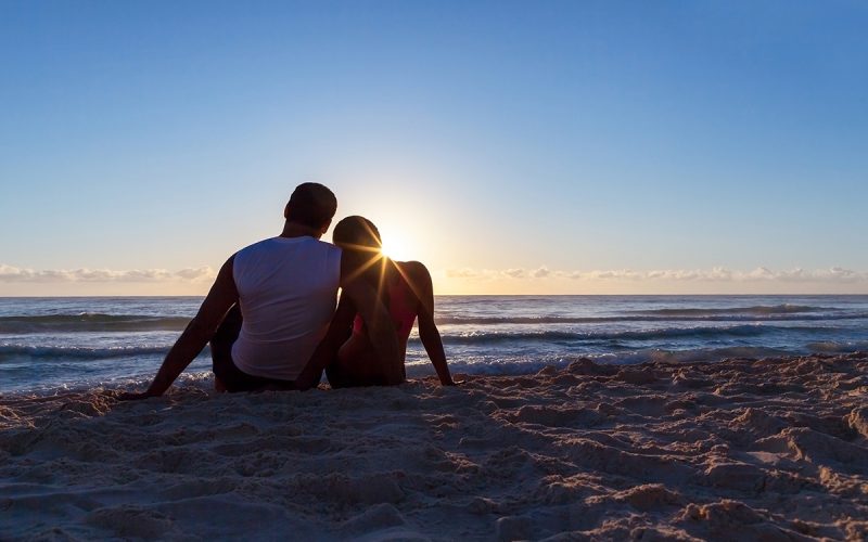Romantic couple watching the sunrise