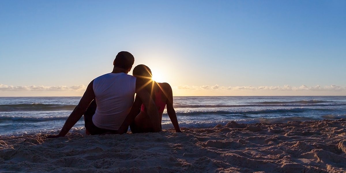 Romantic couple watching the sunrise