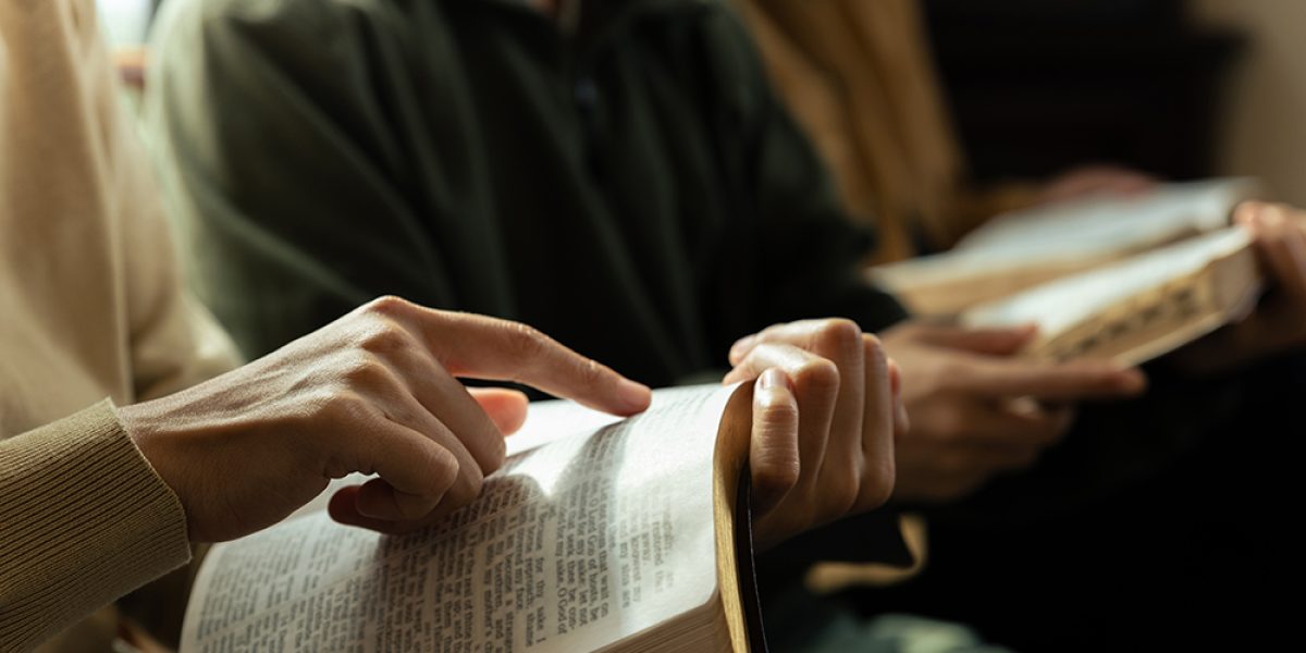Christian group are praying to god with the bible and sharing the gospel, Believe in goodness, Spirituality and religion concept.