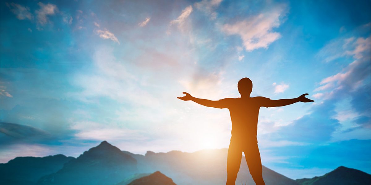 Man standing with arms raised looking at wonderful mountains landscape at sunset. Nature inspiration, happiness, freedom concepts. 3D illustration